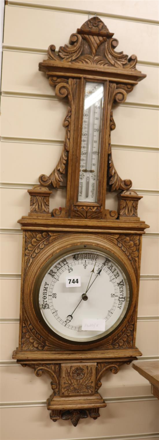An Edwardian oak aneroid barometer, W.30cm